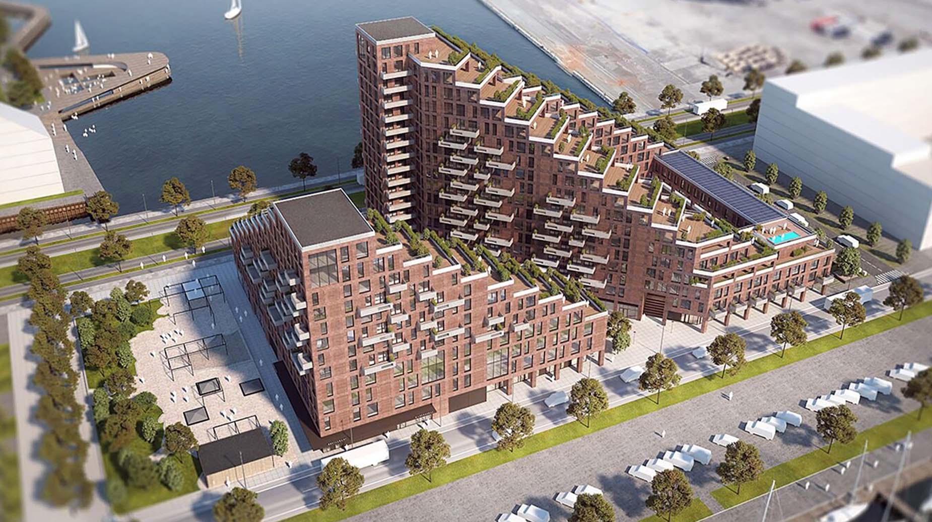 Luftfoto af boligbebyggelse ved havn med grønne tagterrasser og beplantning på trappede tagetager.